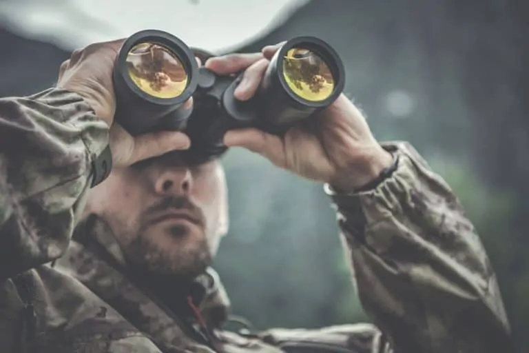 hunting man looking through binoculars