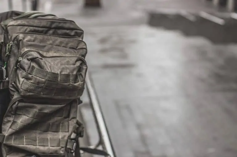 Tactical backpack on floor with molle attachments
