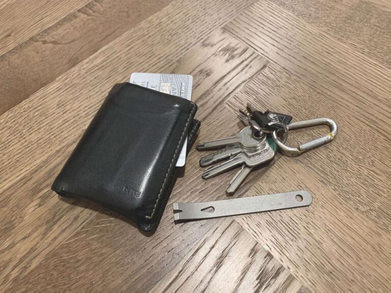 wallet and set of keys set on floor next to edc pry bar for everyday carry