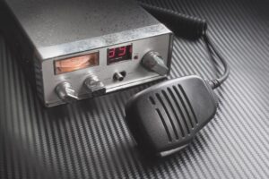 portable cb radio and receiver on table