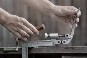 man reloading a shotgun shell with a progressive press