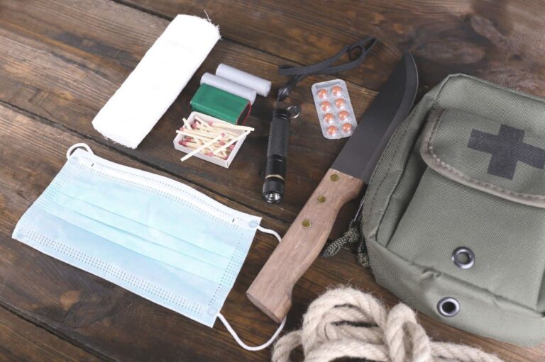 wilderness survival kit contents and bag laid out on table