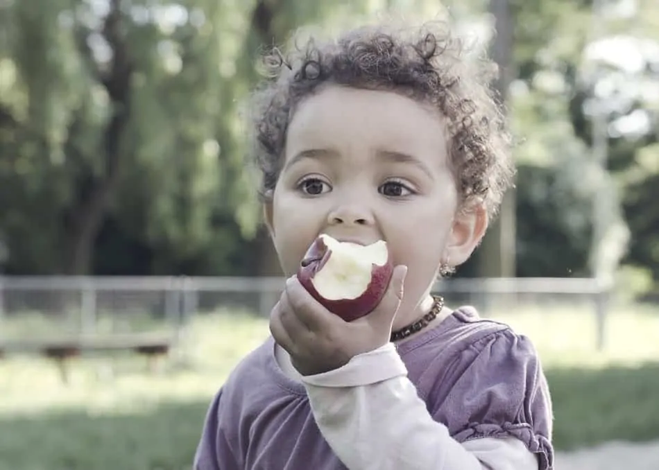 child eating apple as part of good nutrition in diet