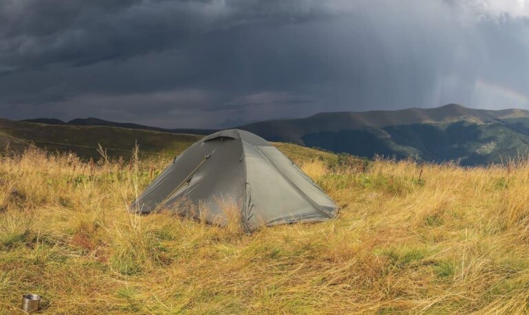 a storm is approaching while camping in the mountains with a waterproof tent