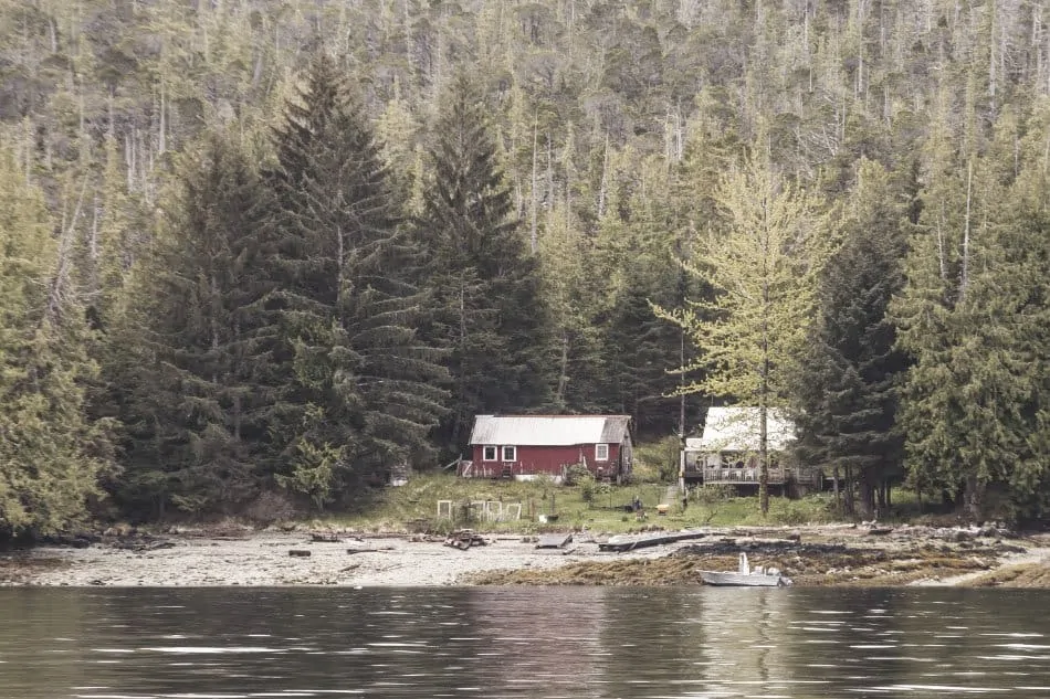 two homes side by side by lake in alaska off grid