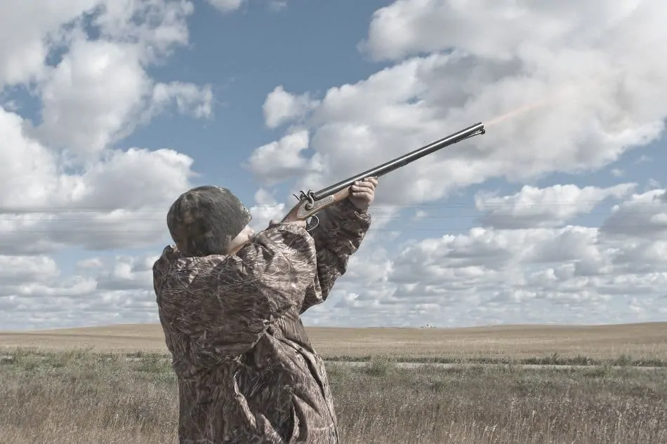 hunter shooting a muzzleloader gun into the air