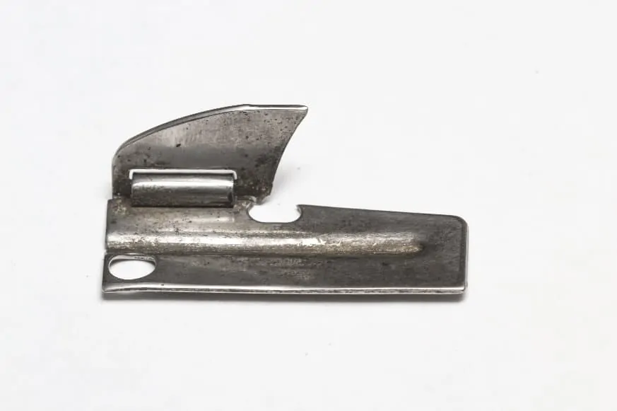 p 38 military can opener on table