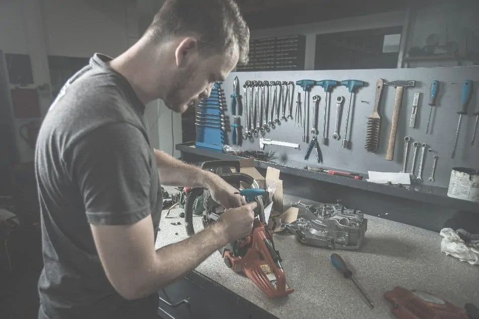 man repairing tools in workshop at home