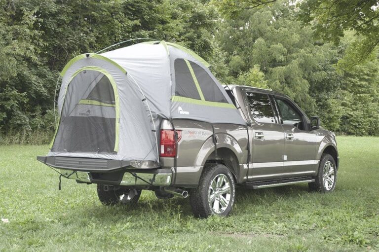 pickup truck on camping ground with a truck tent camper on the rear bed