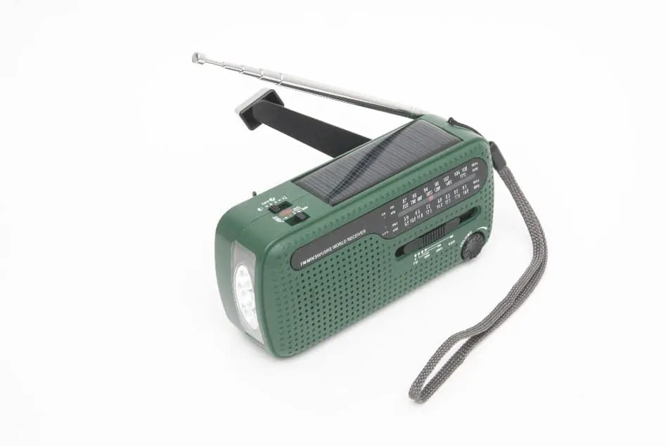 solar powered wind-up crank radio on table