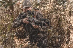 hunter in the trees taking aim with the fastest crossbow