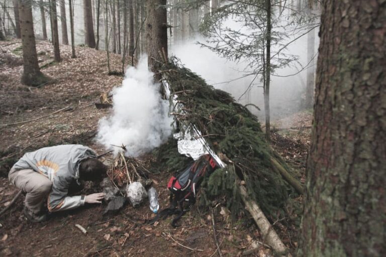 man lighting emergency fire using his survival resources to stay alive