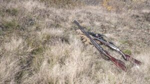 hunting rifles on ground with hunting gear