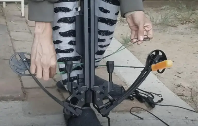 man removing worn string from a crossbow