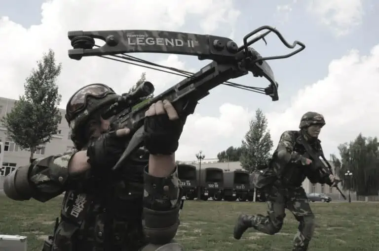 close up of military personell using a crossbow for self defense