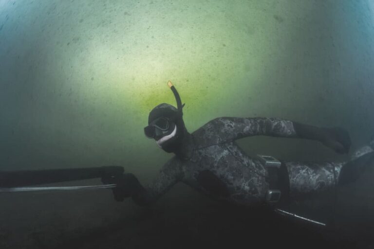 underwater hunter using a crossbow to fish